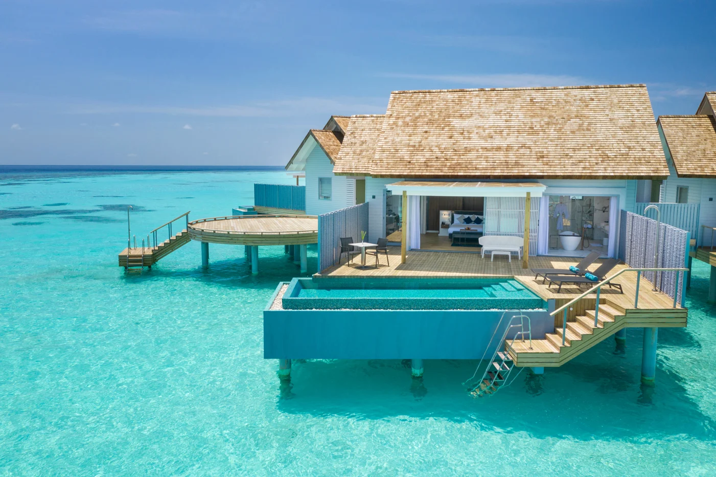 Sunset over water villa with private pool